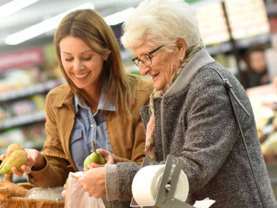 caregiver and senior woman buying groceries
