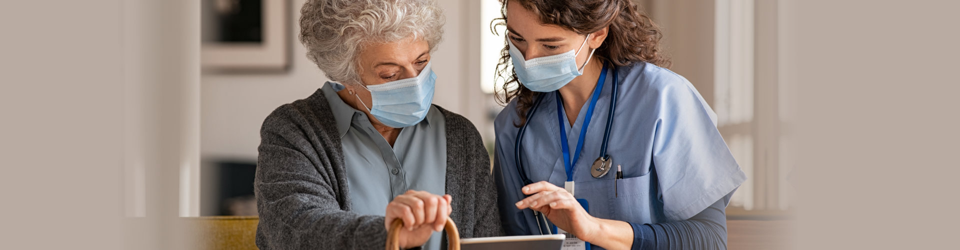 nurse and senior woman wearing a facemask